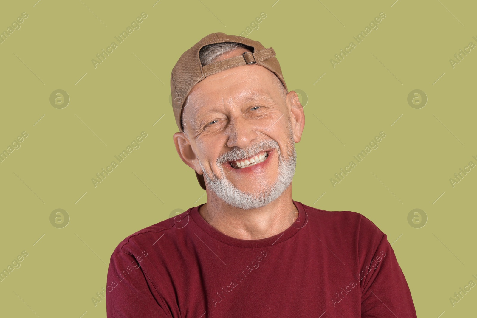 Photo of Portrait of happy senior man on green background