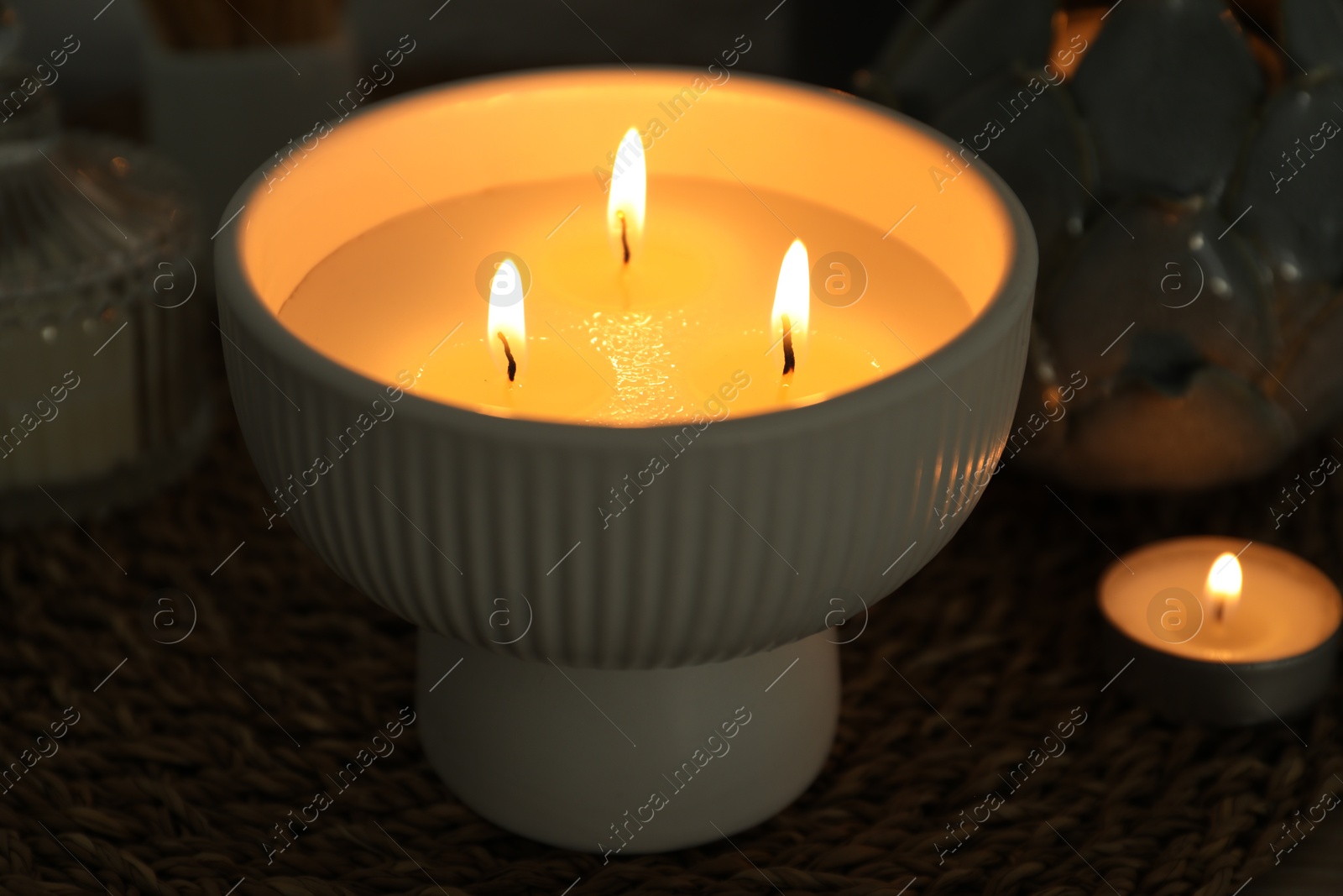 Photo of Burning candles and decor on table, closeup