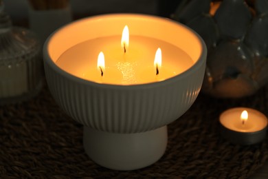 Photo of Burning candles and decor on table, closeup