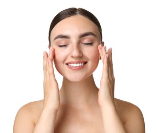 Beautiful young woman doing facial massage on white background