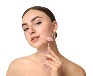 Beautiful young woman doing facial massage with roller on white background