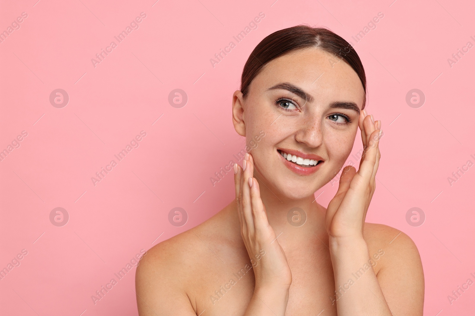 Photo of Beautiful young woman with healthy skin on pink background, space for text