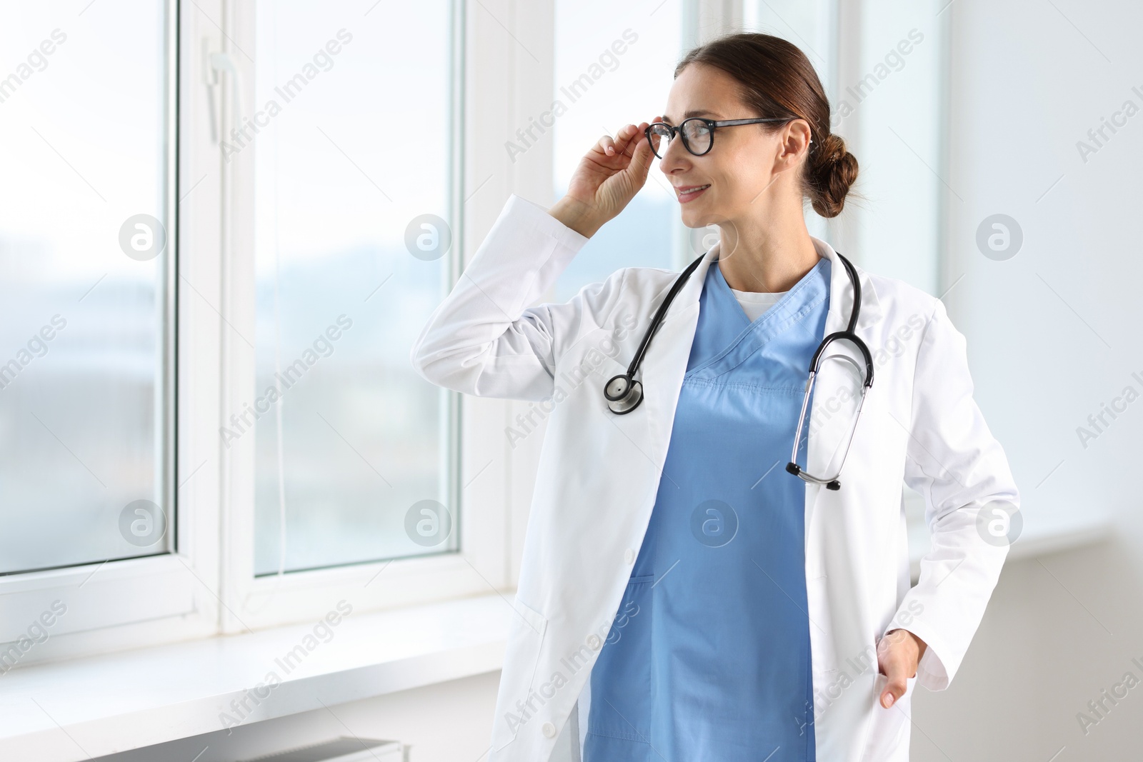 Photo of Nurse with stethoscope near window in clinic