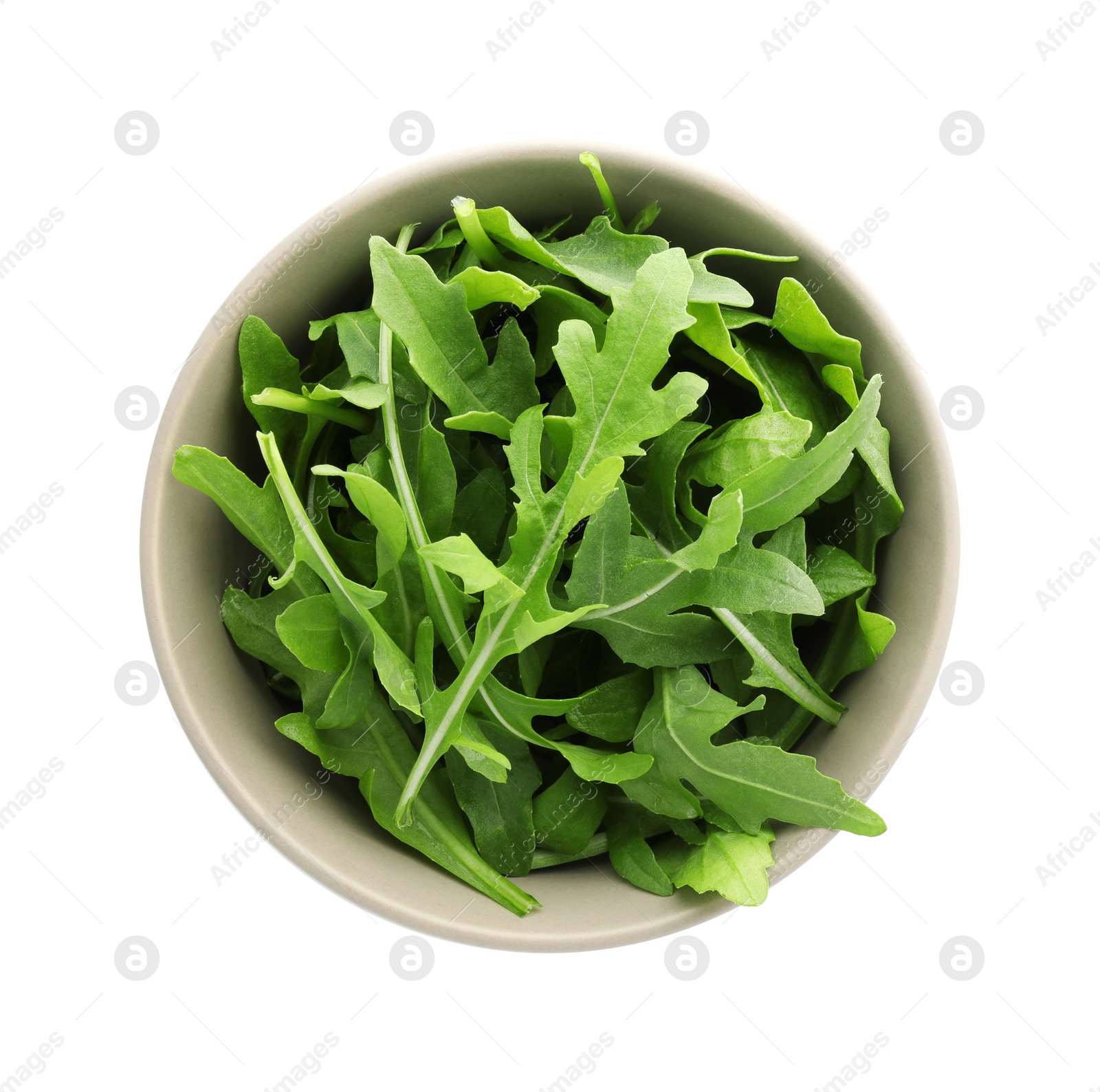 Photo of Fresh arugula leaves in bowl isolated on white, top view