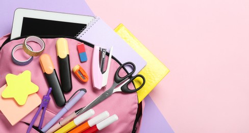 Photo of Backpack and different school stationery on color background, top view. Space for text