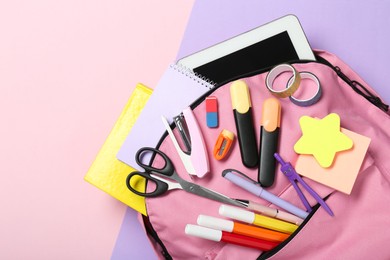 Photo of Backpack and different school stationery on color background, top view. Space for text