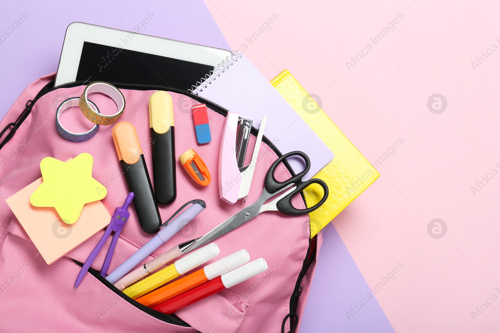 Photo of Backpack and different school stationery on color background, top view. Space for text