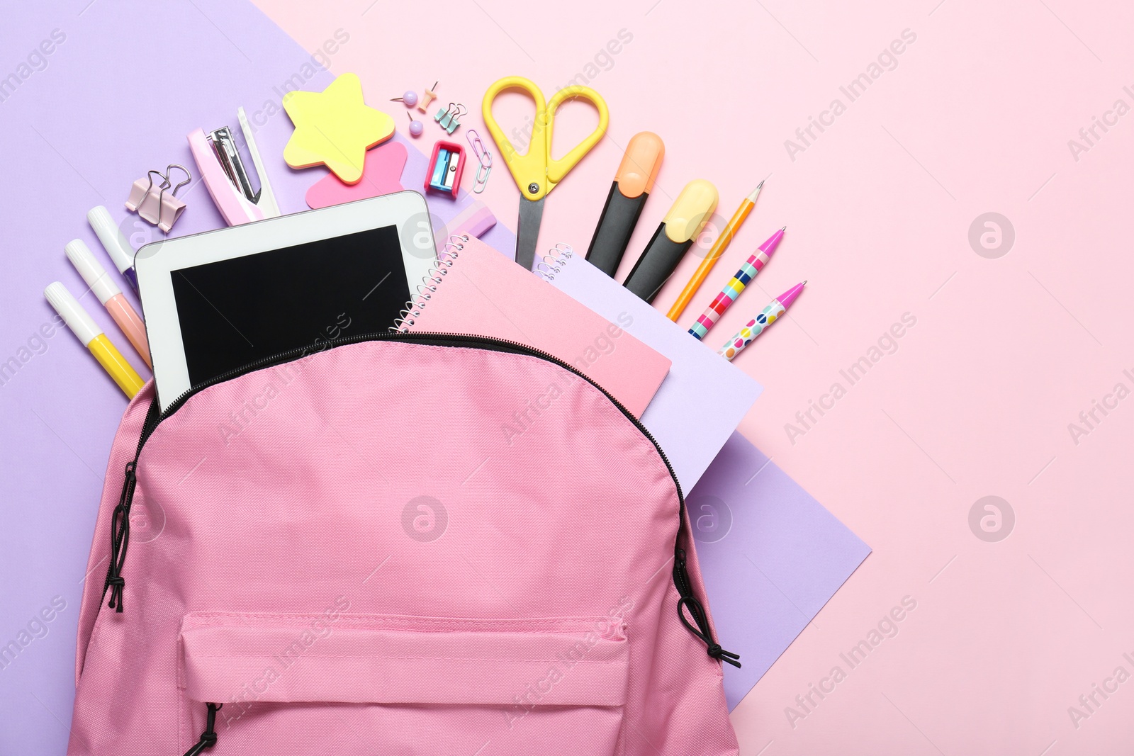 Photo of Backpack and different school stationery on pink background, flat lay. Space for text