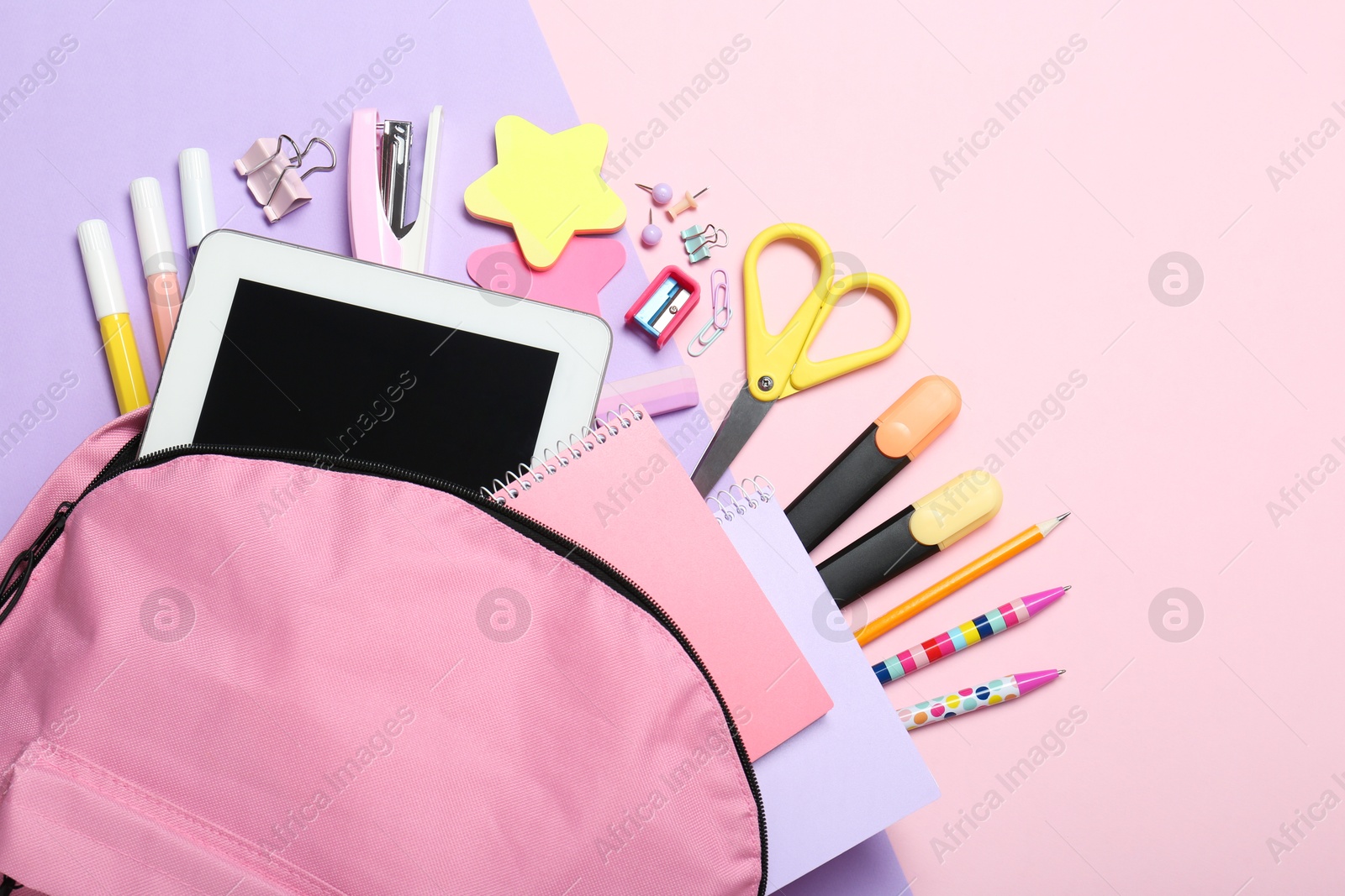 Photo of Backpack and different school stationery on pink background, flat lay. Space for text