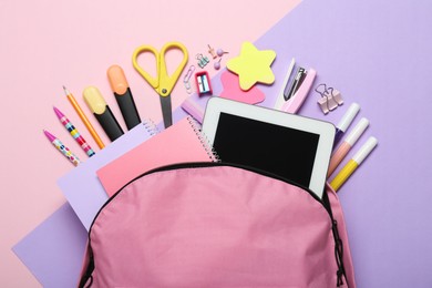 Backpack and different school stationery on pink background, flat lay