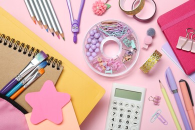 Photo of Backpack and different school stationery on pink background, flat lay