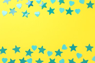 Photo of Beautiful confetti on yellow background, flat lay. Space for text