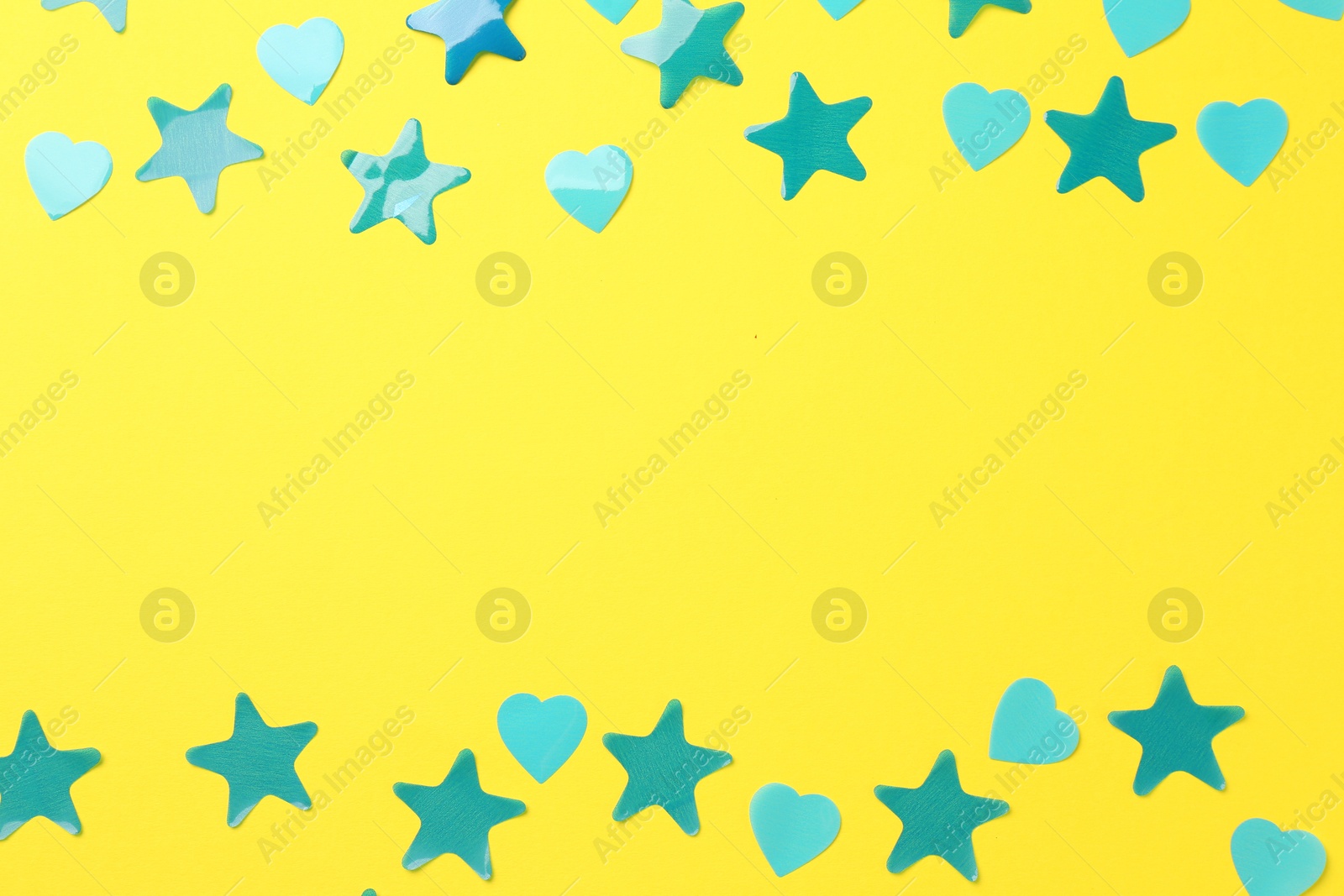 Photo of Beautiful confetti on yellow background, flat lay. Space for text