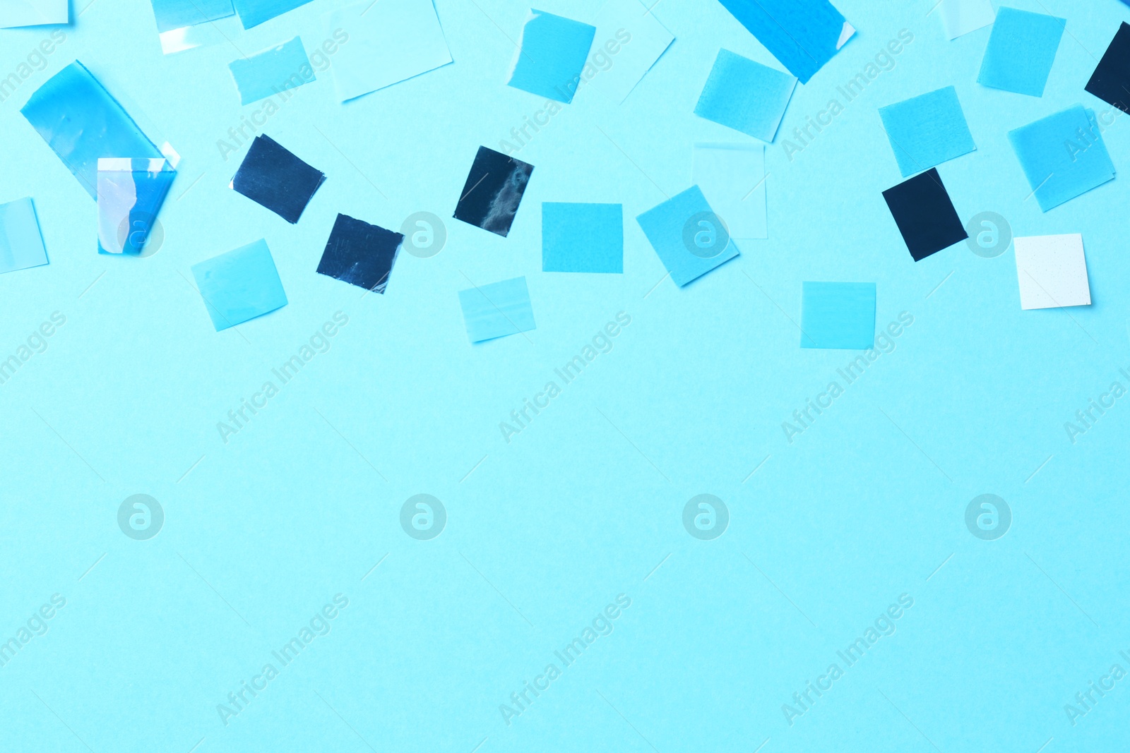 Photo of Beautiful confetti on light blue background, flat lay. Space for text