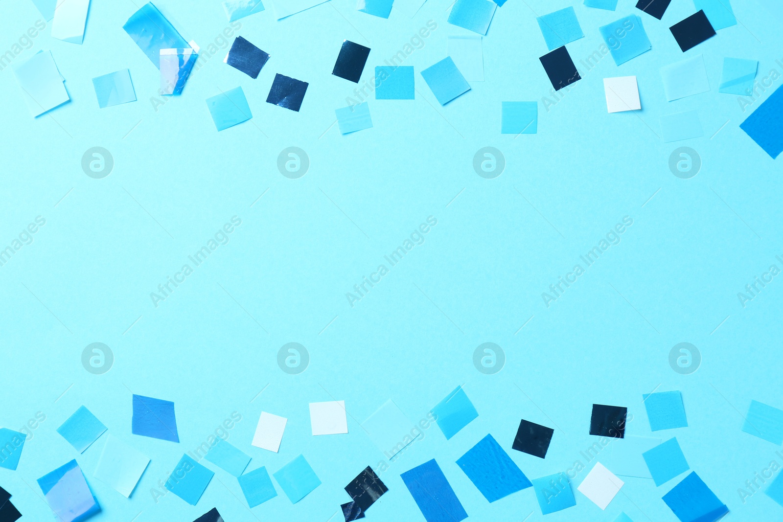 Photo of Beautiful confetti on light blue background, flat lay. Space for text