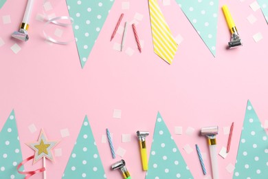 Photo of Confetti, garlands, party horns and candles on pink background, flat lay. Space for text