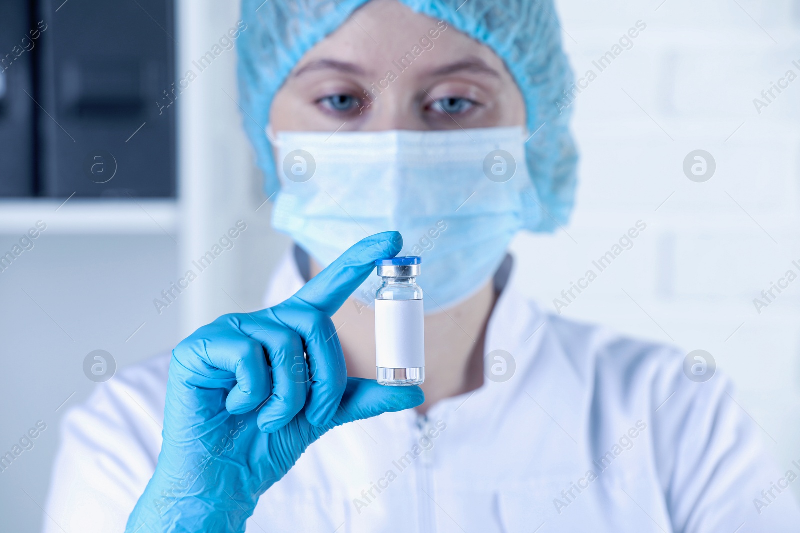 Image of Nurse with glass vial of medication in hospital, selective focus