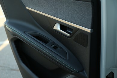 Photo of Closeup view of black car door inside modern automobile