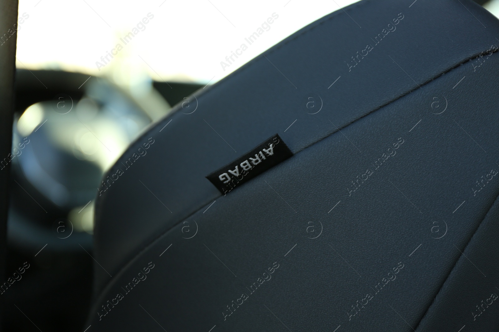 Photo of Safety airbag sign inside of modern car, closeup