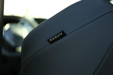 Photo of Safety airbag sign inside of modern car, closeup