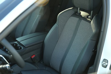 Comfortable seats inside of modern white car, closeup