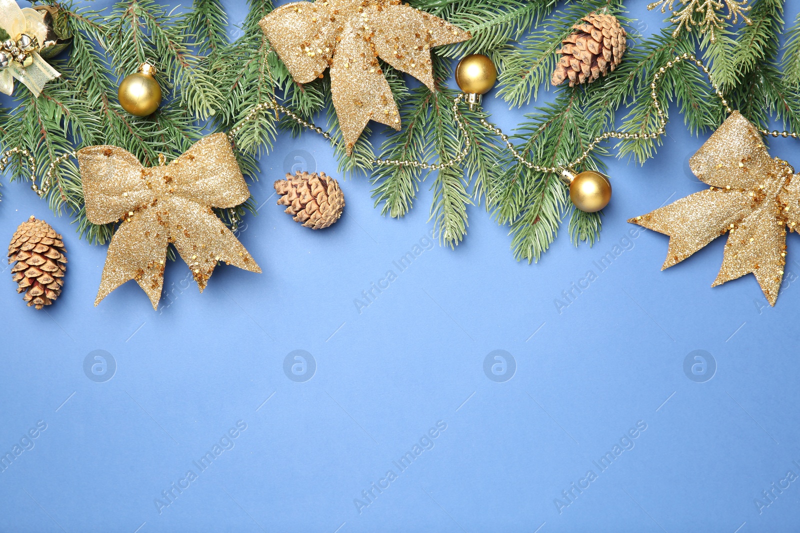 Photo of Flat lay composition with Christmas decor on blue background, space for text