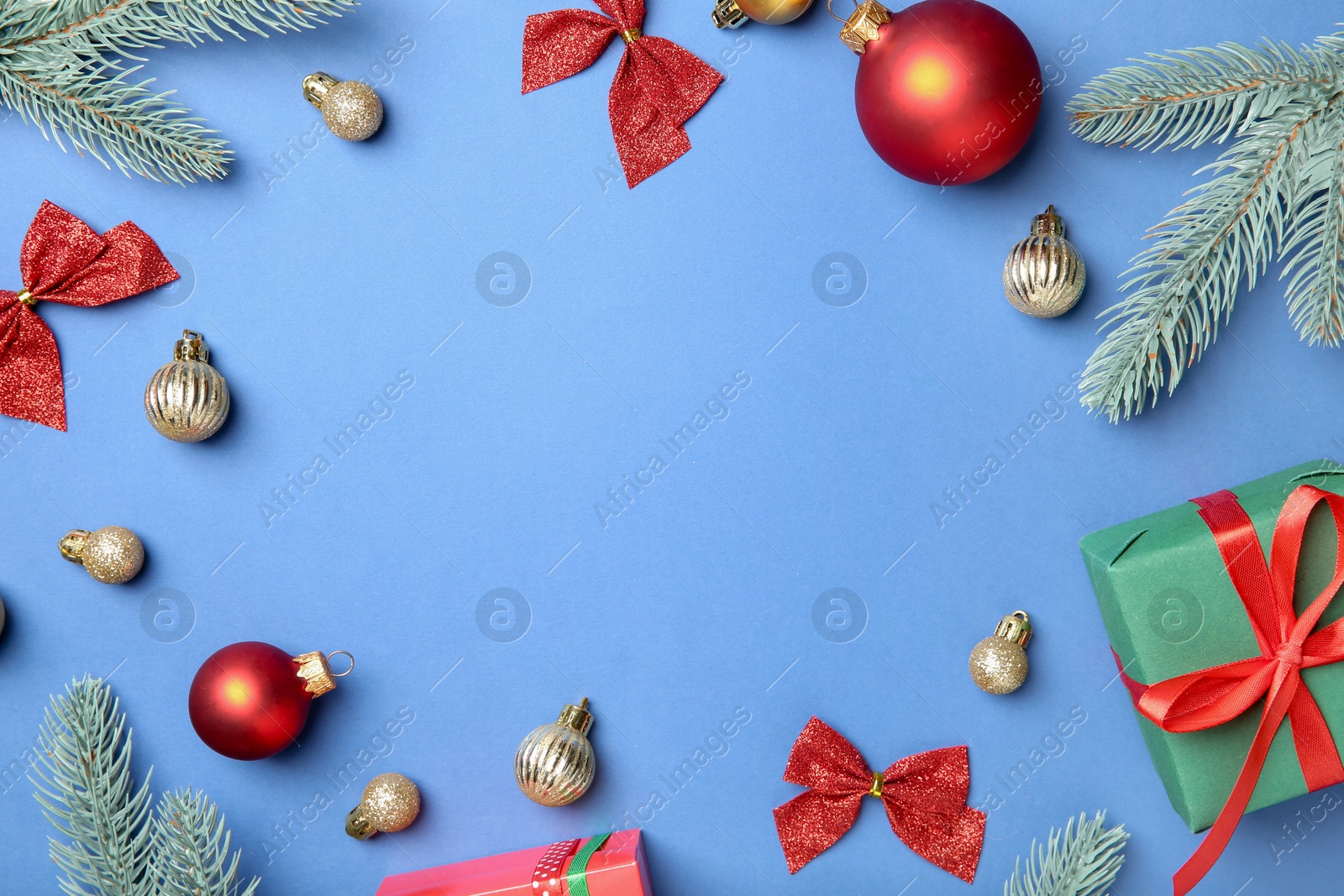 Photo of Flat lay composition with Christmas decor on blue background, space for text