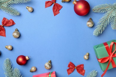 Photo of Flat lay composition with Christmas decor on blue background, space for text