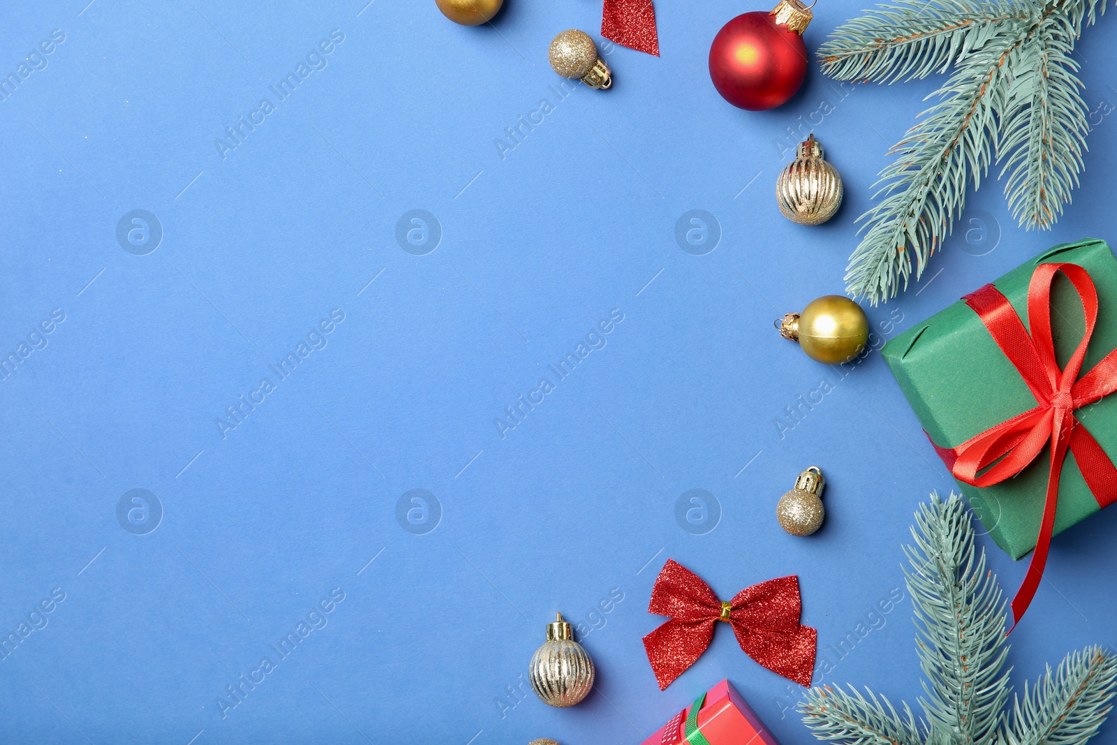 Photo of Flat lay composition with Christmas decor on blue background, space for text