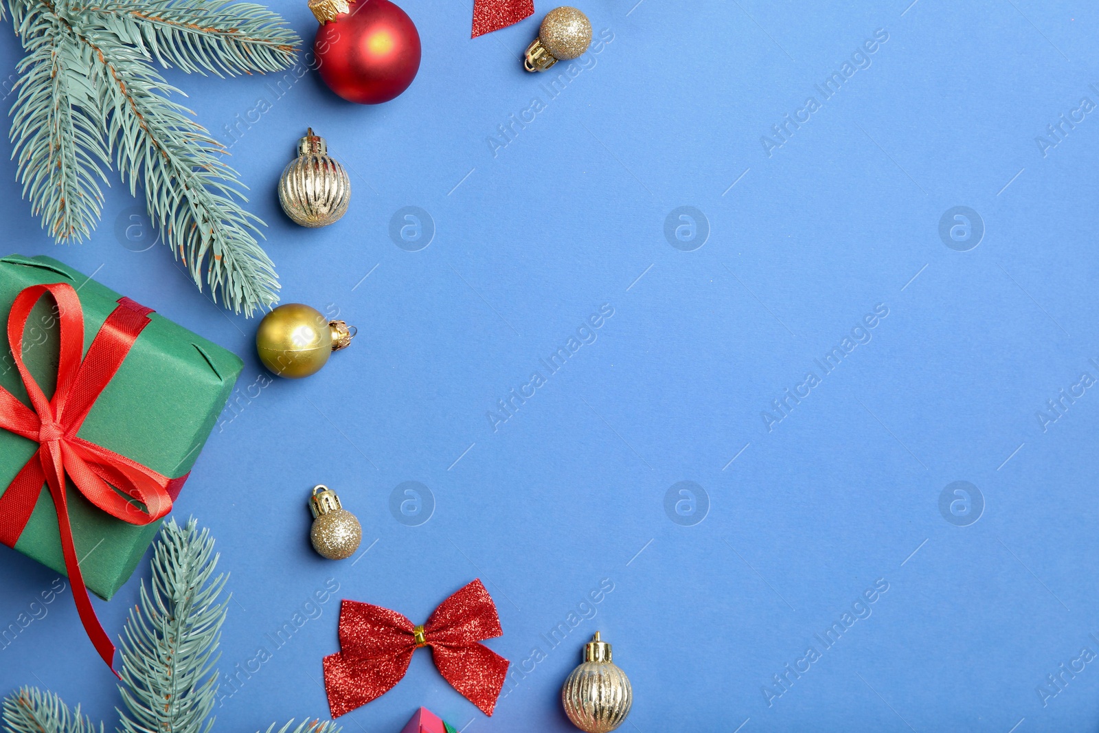 Photo of Flat lay composition with Christmas decor on blue background, space for text