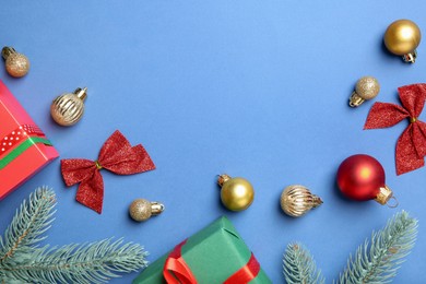 Photo of Flat lay composition with Christmas decor on blue background, space for text