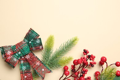 Photo of Flat lay composition with Christmas decor and gift box on beige background. Space for text