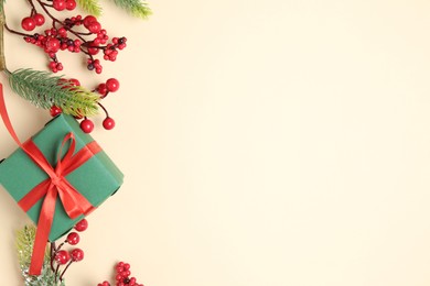 Photo of Flat lay composition with Christmas decor and gift box on beige background. Space for text