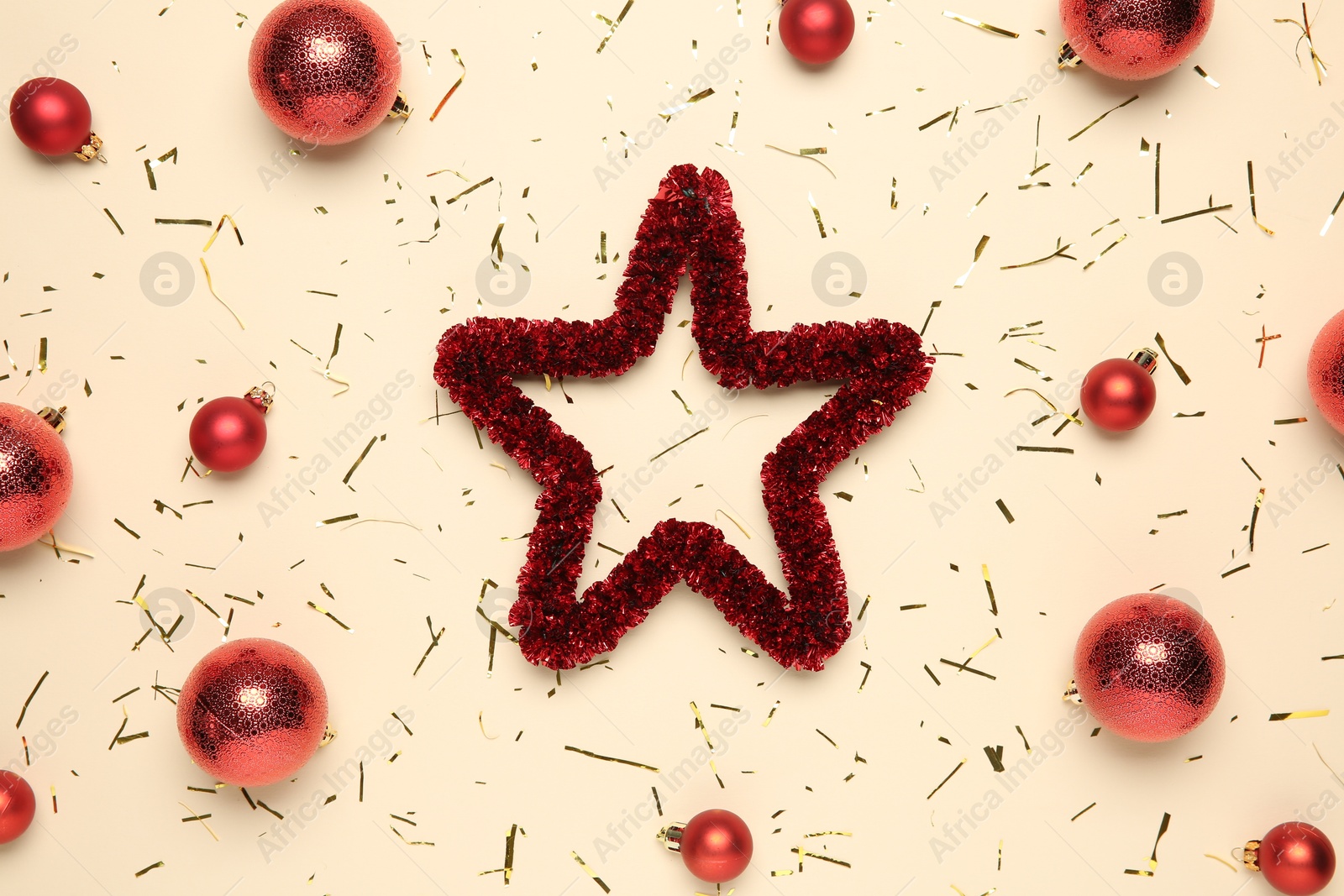 Photo of Flat lay composition with Christmas balls, confetti and decorative star on beige background