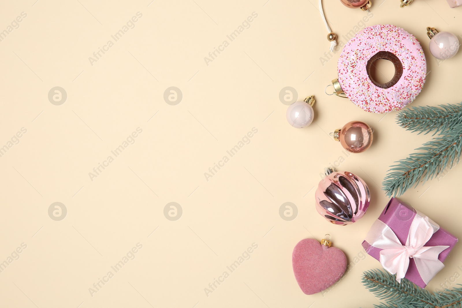 Photo of Flat lay composition with Christmas decor and gift box on beige background. Space for text