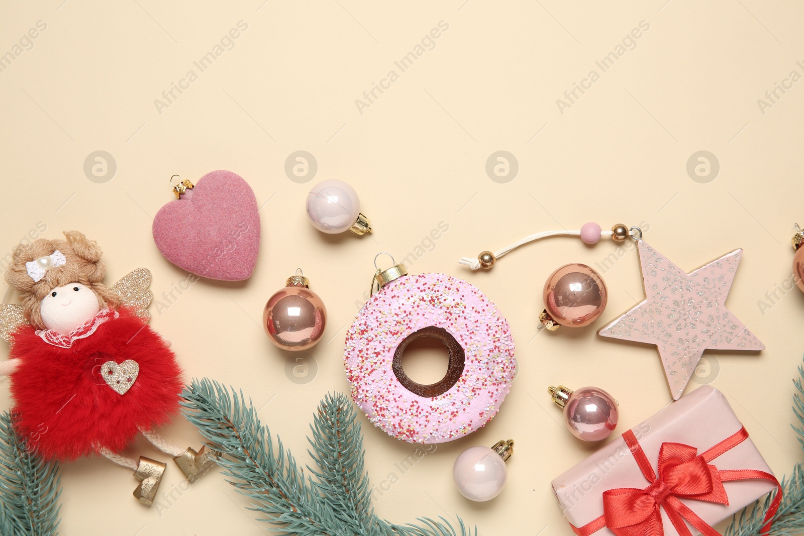 Photo of Flat lay composition with Christmas decor and gift box on beige background. Space for text