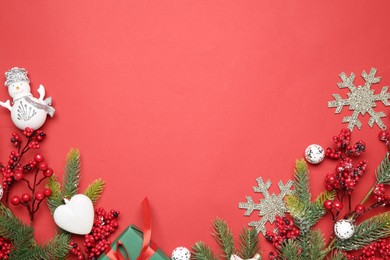 Photo of Flat lay composition with Christmas decor on red background. Space for text