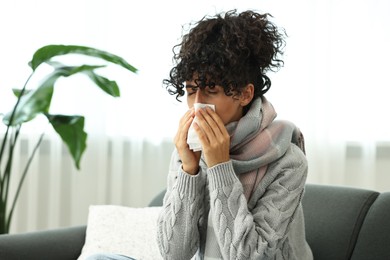 Cold symptom. Young woman with tissue at home