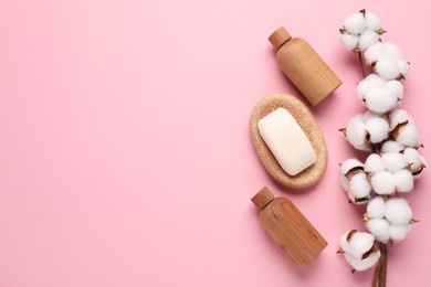 Photo of Different cosmetic products and cotton flowers on pink background, flat lay. Space for text