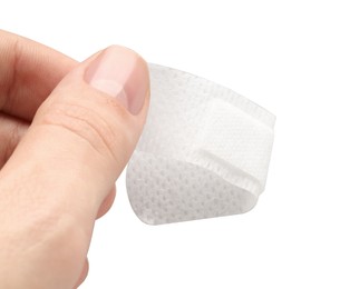 Photo of Woman putting medical adhesive bandage on white background, closeup