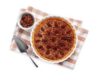 Delicious pecan pie in baking dish, bowl with fresh nuts and cake server isolated on white, top view