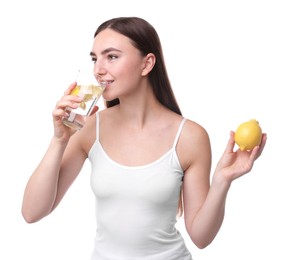 Woman with glass of lemon water and fruit on white background