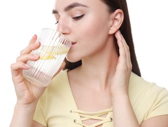 Photo of Woman drinking water with lemon on white background, closeup