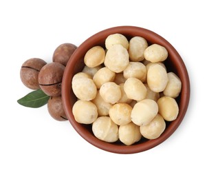 Photo of Macadamia nuts in bowl isolated on white, top view