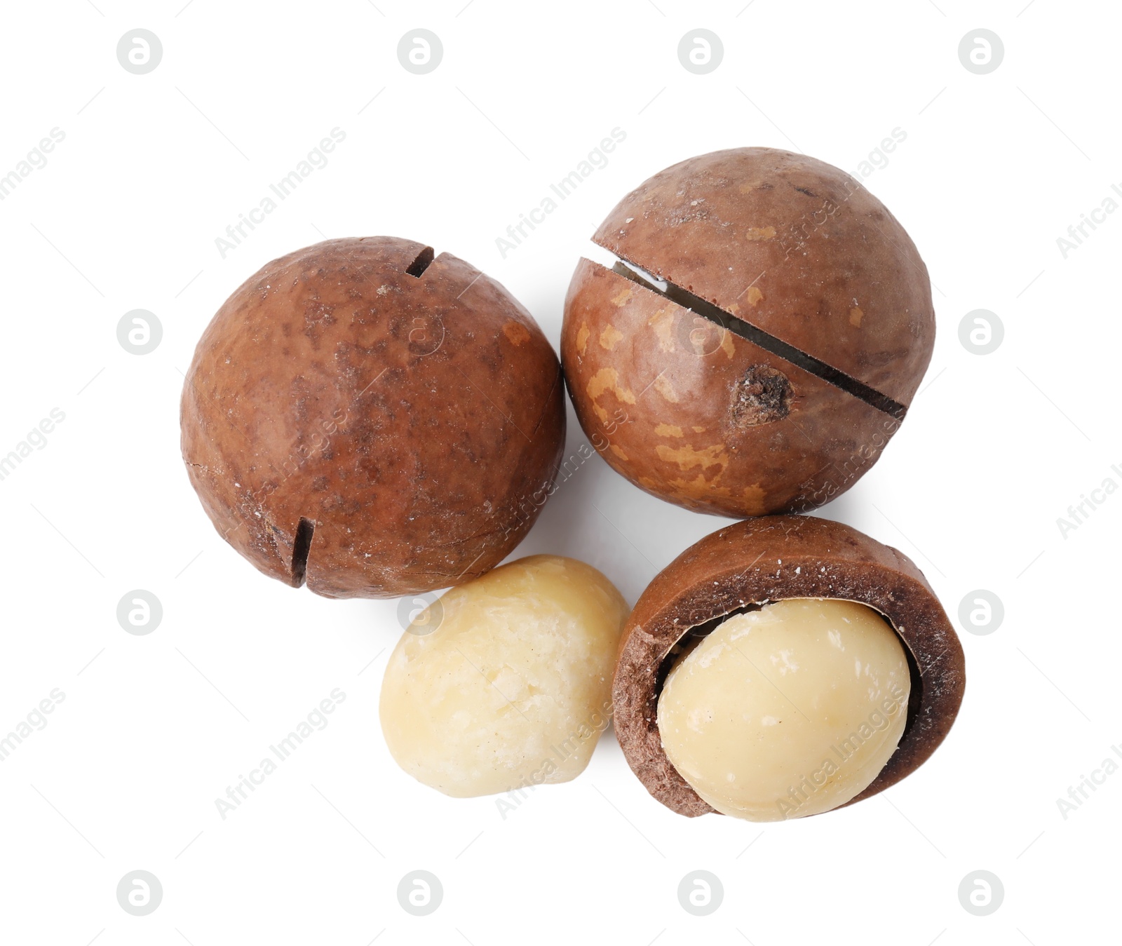 Photo of Macadamia nuts with shells isolated on white, top view