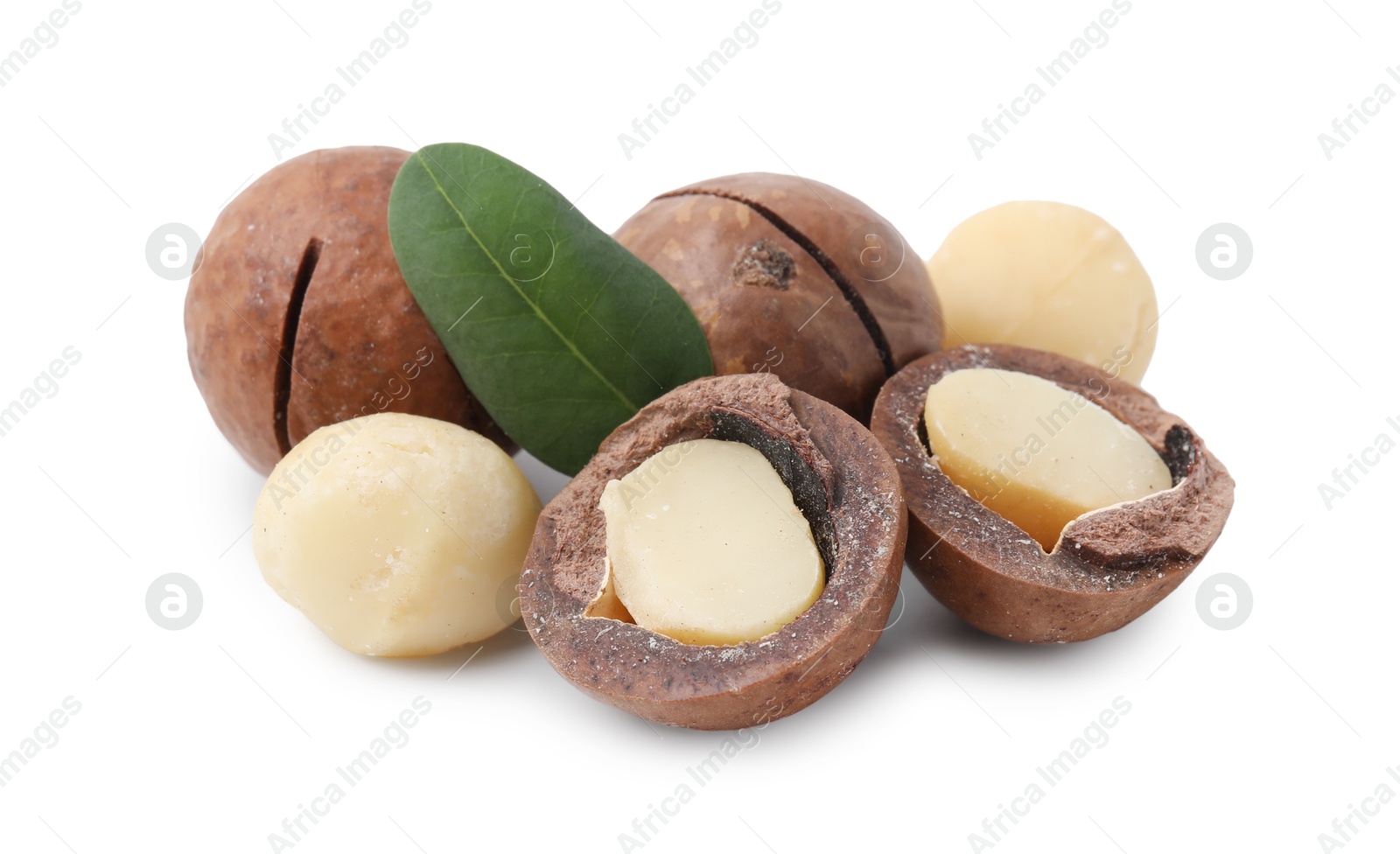 Photo of Macadamia nuts with shells isolated on white