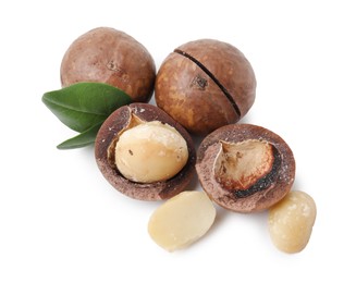 Photo of Macadamia nuts with shells isolated on white