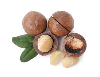 Photo of Macadamia nuts with shells isolated on white, top view