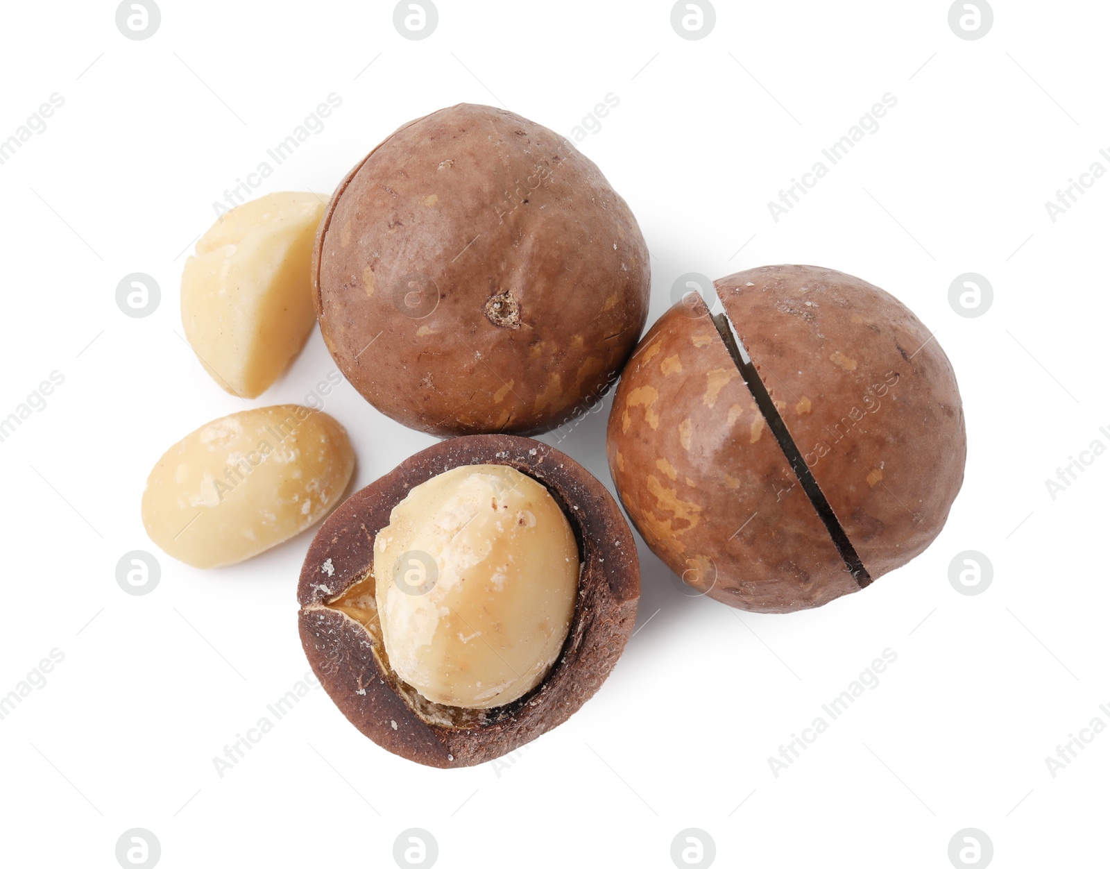 Photo of Macadamia nuts with shells isolated on white, top view