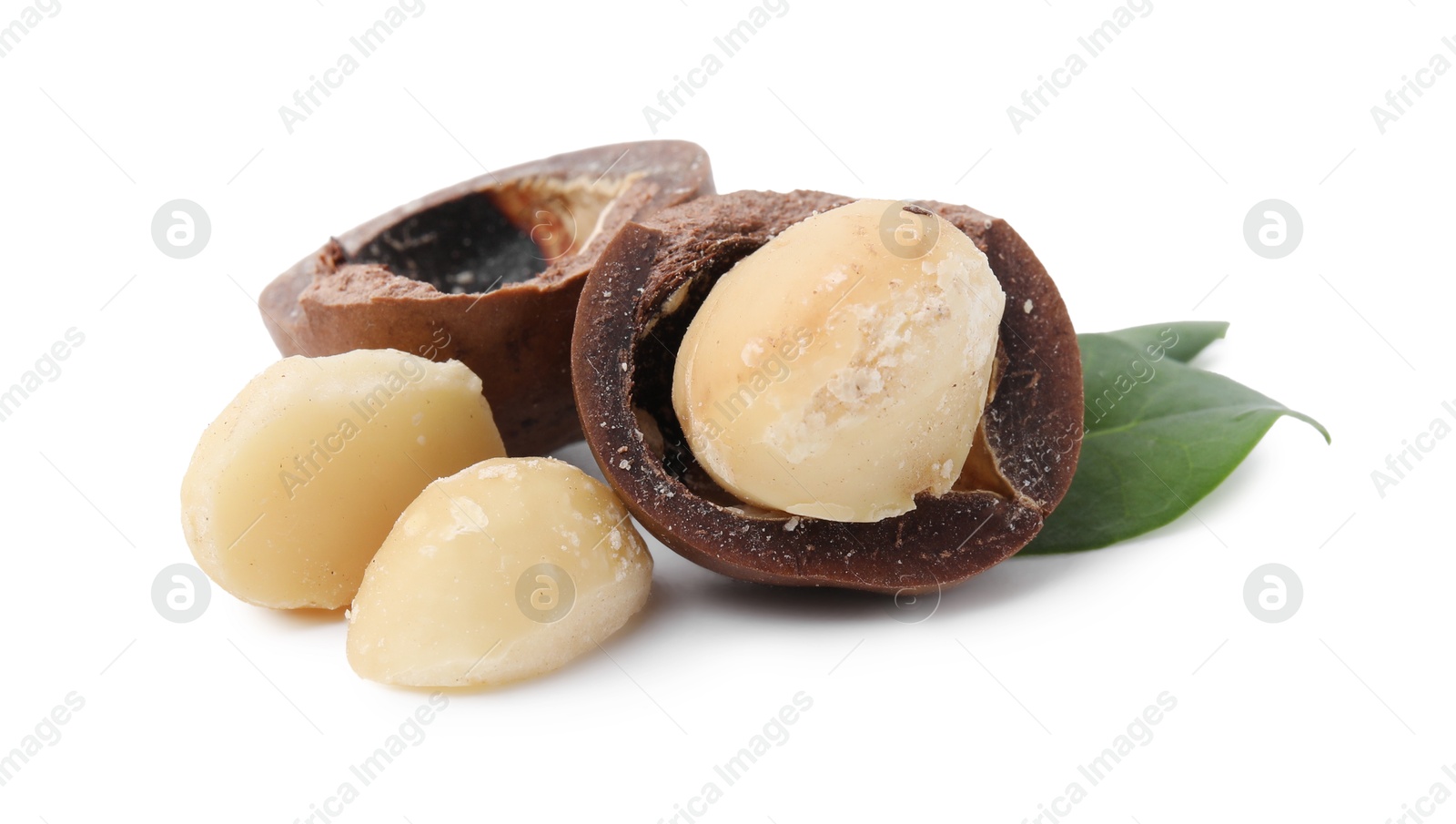 Photo of Macadamia nuts with shells isolated on white